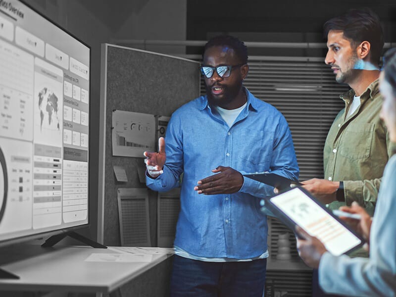 An image of people strategizing and looking at plans.